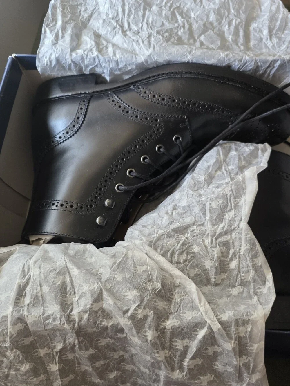 Polo Ralph Lauren lace-up leather boots feature classic wingtip brogue detailing